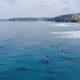 Aerial Footage Of Surfer Paddling Across The Sea With Scenic View Of The Mountains - After Effects Version